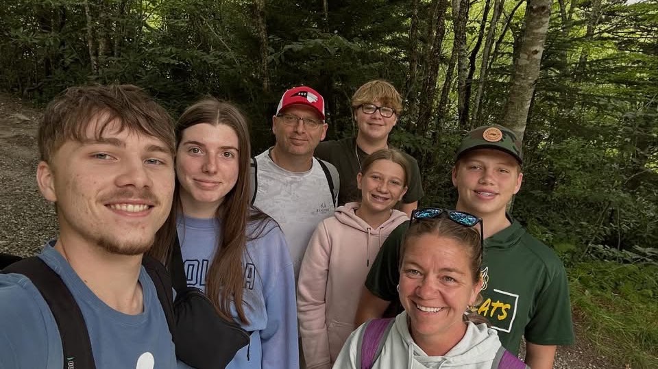Chris Herron with his wife and four children hiking